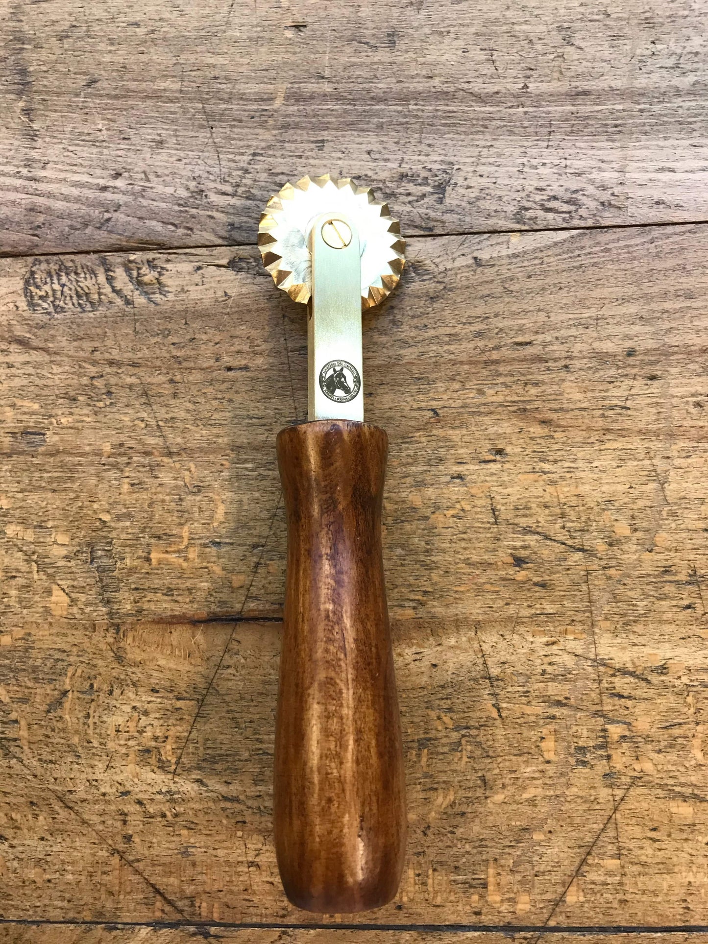 Brass spur with wooden handle